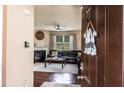 Inviting living room with hardwood floors, fireplace, and view of the sofa through the open doorway at 8553 Braylen Manor Dr, Douglasville, GA 30134