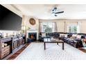 Comfortable living room with large sectional sofa, fireplace, TV, and stylish decor for cozy gatherings at 8553 Braylen Manor Dr, Douglasville, GA 30134