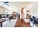 Spacious open-concept living room with hardwood floors, staircase, and seamless flow into the kitchen at 8553 Braylen Manor Dr, Douglasville, GA 30134