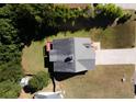 Aerial view of a well-maintained house with a large roof and a spacious, green lawn at 10074 Tara Glynn Dr, Hampton, GA 30228