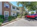 View of the townhome's exterior, showcasing a red car parked in front of it at 10900 Wittenridge Dr # C7, Alpharetta, GA 30022