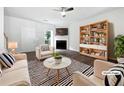 Bright living room with a fireplace, modern ceiling fan, and stylish decor at 25 Timber Ridge Dr, Cartersville, GA 30121