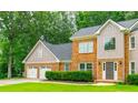 Charming two-story brick home with a three-car garage and manicured landscaping at 3394 Floral Ct, Suwanee, GA 30024