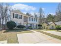 Well-manicured townhome with neutral siding, dark shutters, and a driveway leading to the entrance at 4211 Wingfoot Ct, Decatur, GA 30035