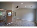 Open-concept living room with a high ceiling, modern ceiling fan, and a decorative accent wall at 5072 Plantation View Trl, Stone Mountain, GA 30088