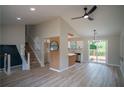 Bright, open living area with high ceilings, modern light fixtures, and seamless access to the kitchen at 5072 Plantation View Trl, Stone Mountain, GA 30088