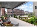A covered back porch with a view of the community and comfortable seating at 6460 Cortland Walk, Alpharetta, GA 30005