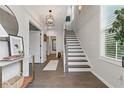 Elegant foyer with hardwood floors, a staircase, and ample natural light at 6460 Cortland Walk, Alpharetta, GA 30005