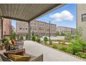 Relaxing outdoor patio space with comfortable seating and views of lush landscaping at 6460 Cortland Walk, Alpharetta, GA 30005