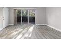 Bright living room with sliding glass doors to balcony and modern gray wood flooring at 765 Houston Mill Ne Rd # 7, Atlanta, GA 30329