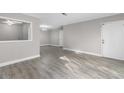 Spacious living room with gray wood flooring, neutral walls, and ample natural light at 765 Houston Mill Ne Rd # 7, Atlanta, GA 30329