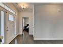 Bright entryway featuring hardwood floors, transom windows, and a view into a bedroom at 1891 Primrose Park Rd, Sugar Hill, GA 30518