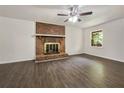 The living room features a striking brick fireplace and ample natural light from the window at 20 Shadow Creek Dr, Villa Rica, GA 30180
