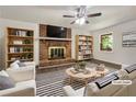 Bright living room with a brick fireplace, ceiling fan and stylish decor at 20 Shadow Creek Dr, Villa Rica, GA 30180