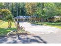 Brick house with a long driveway and rose bushes in the front yard at 2648 Oswood Dr, Tucker, GA 30084