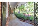 Inviting front porch with black iron details and beautiful landscaping featuring vibrant pink flowers at 2648 Oswood Dr, Tucker, GA 30084