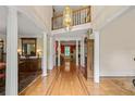 Grand foyer boasts hardwood floors, soaring ceilings, and an elegant chandelier at 312 Crabapple Springs Way, Woodstock, GA 30188