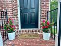 Welcoming front door with flowerpots and a 'hope you brought wine' doormat at 4875 Carre Way, Alpharetta, GA 30022