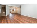Open-concept living space showcasing hardwood floors and seamless transition to the adjacent kitchen at 112 Hawkeye Ln, Conyers, GA 30012