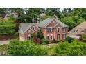 Beautiful two-story brick home with manicured lawn and mature trees at 1850 Mallard Lake Dr, Marietta, GA 30068