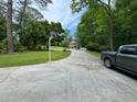 Spacious driveway leading to a well-maintained home amidst lush greenery at 2671 Club Forest Se Ct, Conyers, GA 30013