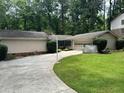 Charming home with manicured lawn, featuring a basketball hoop and attached garage at 2671 Club Forest Se Ct, Conyers, GA 30013
