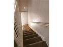 A carpeted stairway with white rails adds charm to the home's interior, connecting different levels at 2751 Penwood Pl, Lithonia, GA 30058