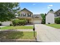 Inviting two-story home featuring a well-maintained lawn, a two-car garage, and a charming front porch at 3340 Ivey Rdg, Buford, GA 30519