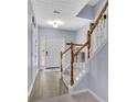 Bright entryway with gray paint, staircase, wood railing, and hardwood floors at 541 Lantern Wood Dr, Scottdale, GA 30079