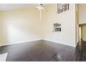 Spacious room featuring a ceiling fan, hardwood floors, and a view of the kitchen at 5867 Trent Walk Dr, Lithonia, GA 30038
