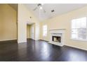 Spacious living room with fireplace, high ceilings, and elegant hardwood floors at 5867 Trent Walk Dr, Lithonia, GA 30038