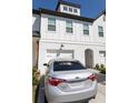 Charming townhouse with white brick and siding and attached garages at 82 Auburn Run Ln, Auburn, GA 30011