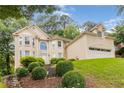 Elegant two-story home showcasing lush front lawn, attached two car garage, and well-maintained landscaping at 2280 Wildwood Lake Dr, Suwanee, GA 30024