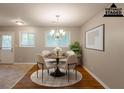 Staged dining room with hardwood floors, a decorative rug, and modern chandelier at 4345 Kimball Sw Rd, Atlanta, GA 30331