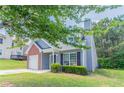 Beautiful home with a brick accent, manicured landscaping, and attached garage at 4695 Ravenwood Loop, Union City, GA 30291