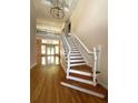 Grand foyer with hardwood floors, staircase, and an elegant chandelier at 4770 Powers Park Ne Ct, Marietta, GA 30067