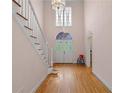 Entryway showcases hardwood floors, staircase, and double-door entrance at 4770 Powers Park Ne Ct, Marietta, GA 30067
