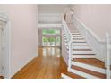 Bright foyer featuring hardwood floors, staircase, and entrance to the living area at 4770 Powers Park Ne Ct, Marietta, GA 30067
