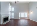 Bright living room features a fireplace, hardwood floors, and large windows at 6509 Charter Way, Lithonia, GA 30058