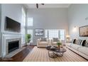Bright, staged living room features a fireplace, wood floors, and comfortable modern furnishings at 6509 Charter Way, Lithonia, GA 30058