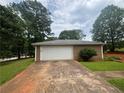 Exterior view of a one-car garage featuring a white door and neutral siding at 6668 Prinston Cir, Douglasville, GA 30135