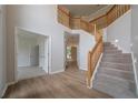 Bright foyer with wood floors, carpeted staircase and railing, and neutral walls at 4495 Riders Ridge Trl, Snellville, GA 30039