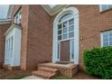Close-up of a brick home's front entrance with a grand arched window above the door at 4495 Riders Ridge Trl, Snellville, GA 30039