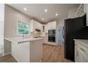 Modern kitchen with white cabinets, quartz countertops, stainless steel appliances at 4495 Riders Ridge Trl, Snellville, GA 30039