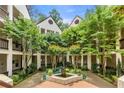 Beautiful courtyard features lush landscaping, mature trees, and a central fountain at 472 Sherman Way, Decatur, GA 30033