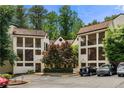 Exterior view of condo buildings with balconies, landscaping, and parking at 472 Sherman Way, Decatur, GA 30033