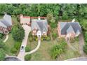 Aerial view of a red brick home with mature trees and pristine landscaping at 470 Manor Oak Se Ln, Marietta, GA 30067