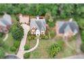 Aerial perspective of a brick residence with mature landscaping, a winding walkway, and a well-manicured lawn at 470 Manor Oak Se Ln, Marietta, GA 30067