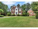 Beautiful two-story brick home with a large, well-maintained front yard at 470 Manor Oak Se Ln, Marietta, GA 30067