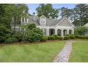 Beautiful home with manicured lawn and stone walkway, surrounded by mature trees at 635 Wilson Nw Rd, Atlanta, GA 30318